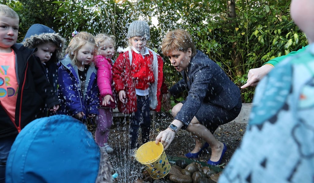 Scotland's First Minister Nicola Sturgeon has a look at the water feature with children during a visit to Sauchie Nursery School in Alloa, southern Scotland, on Wednesday. Photo: AFP Scotland's First Minister Nicola Sturgeon has a look at the water feature with children during a visit to Sauchie Nursery School in Alloa, southern Scotland, on Wednesday. Photo: AFP