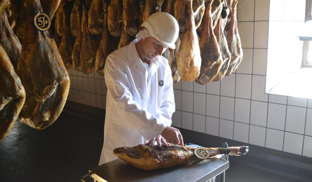 An inspector performs a quality control check on a leg of jamon iberico in Huelva, Spain, in November 2016. Photo: Chris Dwyer