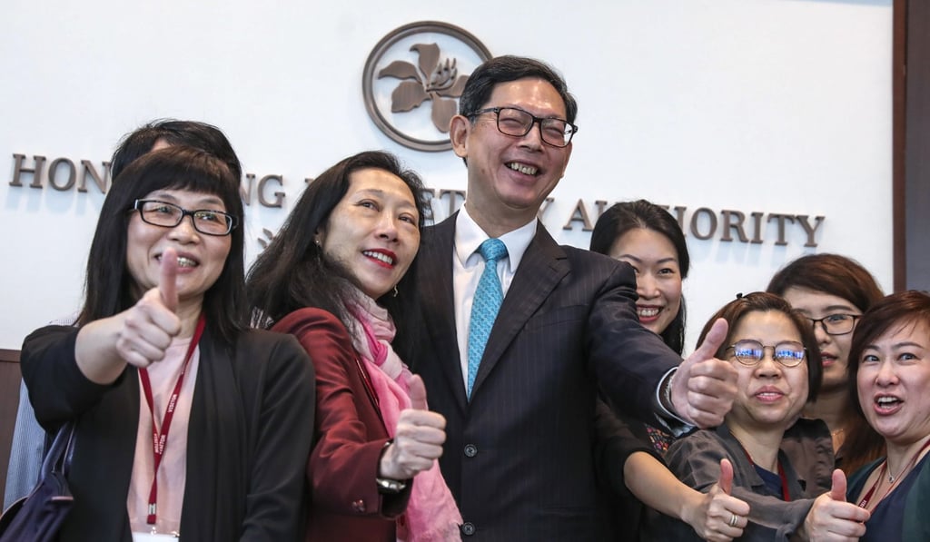 Retiring Hong Kong Monetary Authority chief executive Norman Chan Tak-lam with reporters at Two International Finance Centre (IFC) in Central. Photo: SCMP