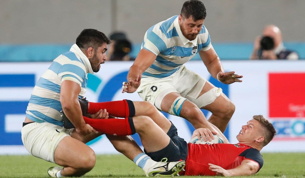 England centre Owen Farrell is tackled against Argentina. Photo: AFP England centre Owen Farrell is tackled against Argentina. Photo: AFP