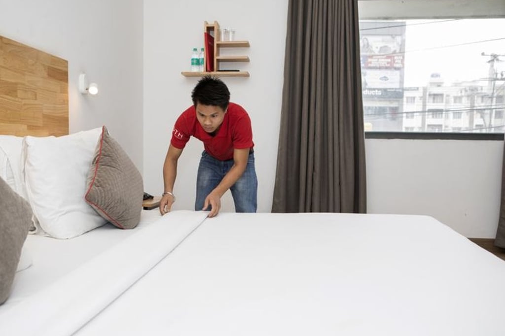 An employee makes a bed in a room at an Oyo town house in Bangalore on September 11. Photo: Bloomberg