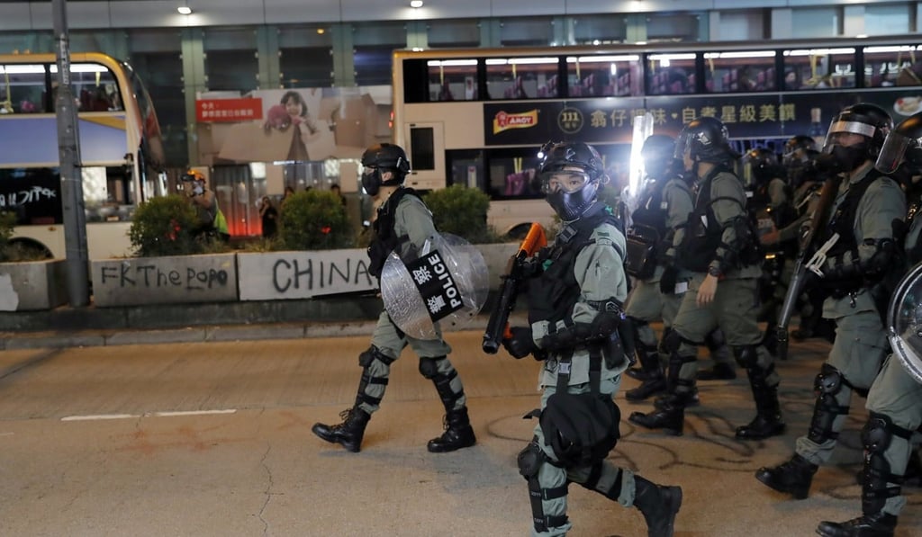 Riot police search for anti-government protesters that have blocked a road with barricades in Hong Kong’s Mong Kok district on Monday. Photo: Reuters Riot police search for anti-government protesters that have blocked a road with barricades in Hong Kong’s Mong Kok district on Monday. Photo: Reuters