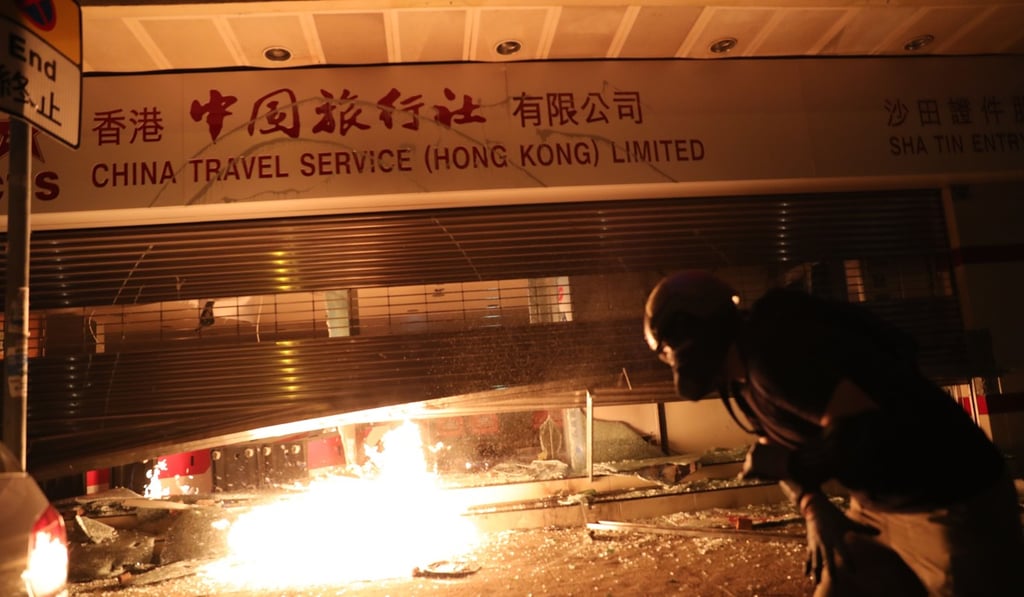 Anti-government protesters set fire to a China Travel Service branch in Sha Tin as they target businesses linked to mainland China. Photo: Sam Tsang Anti-government protesters set fire to a China Travel Service branch in Sha Tin as they target businesses linked to mainland China. Photo: Sam Tsang