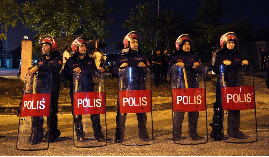 Malaysian police officers guard the entrance to a temple in Kuala Lumpur last year. Photo: AP