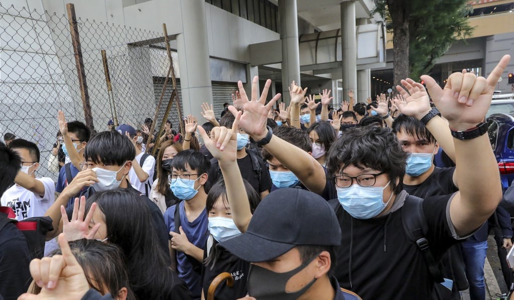 Protesters gather outside Eastern Court in Sai Wan Ho, where the first protesters charged with wearing face masks appeared in court on Monday. Photo: May Tse Protesters gather outside Eastern Court in Sai Wan Ho, where the first protesters charged with wearing face masks appeared in court on Monday. Photo: May Tse