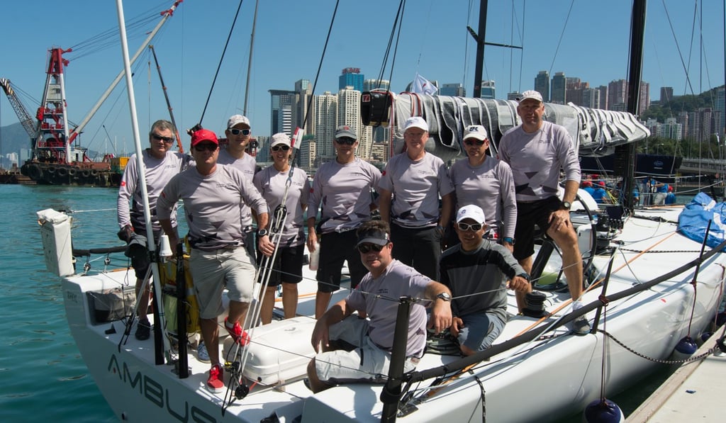 Ambush sailing team. Joachim Isler (back row, far right), Andrew Taylor (front row, first in the middle, seated, with a black cap). Photo: Naomi Rebecca