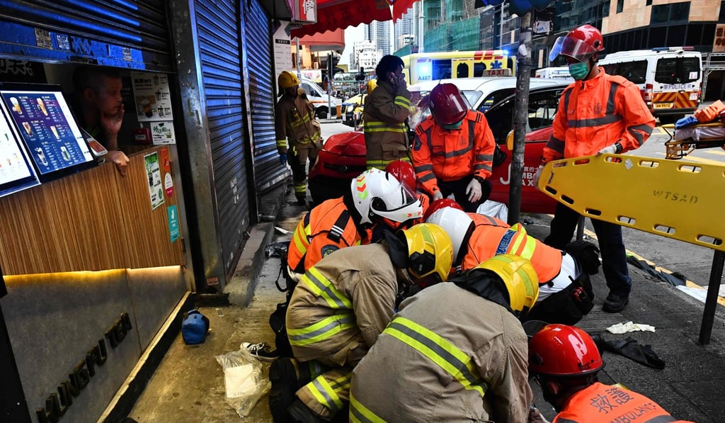 The injured woman receives treatment on the roadside after the taxi incident on Sunday. Photo: AFP The injured woman receives treatment on the roadside after the taxi incident on Sunday. Photo: AFP