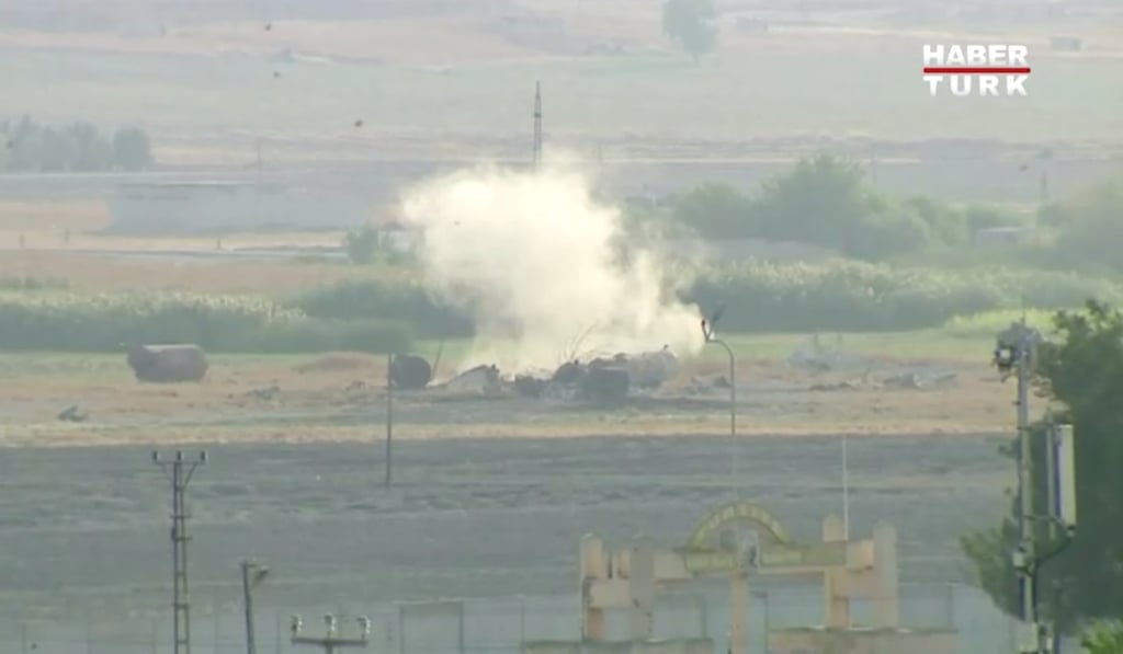 Smoke rises from an explosion in the border town of Tel Abyad, Syria, as seen from Akcakale, Turkey. Photo: Haberturk via Reuters TV