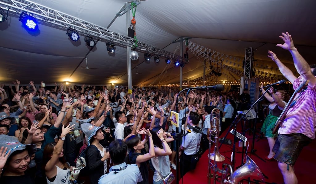Revellers respond to the house musicians of the Marco Polo German Bierfest, the Notenhobler Band from Germany.