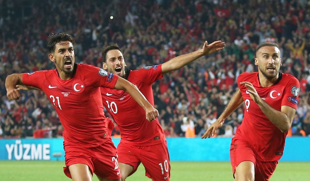 Turkey's forward Cenk Tosun (R) celebrates with his teammates after scoring a goal during the Euro 2020 football qualification match between Turkey and Albania at the Ulker Stadium in Istanbul on October 11. Photo: AFP