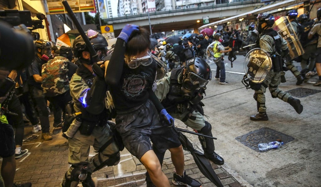 Scuffles between riot police and anti-government protesters. Clashes have become increasingly violent in recent weeks. Photo: Winson Wong