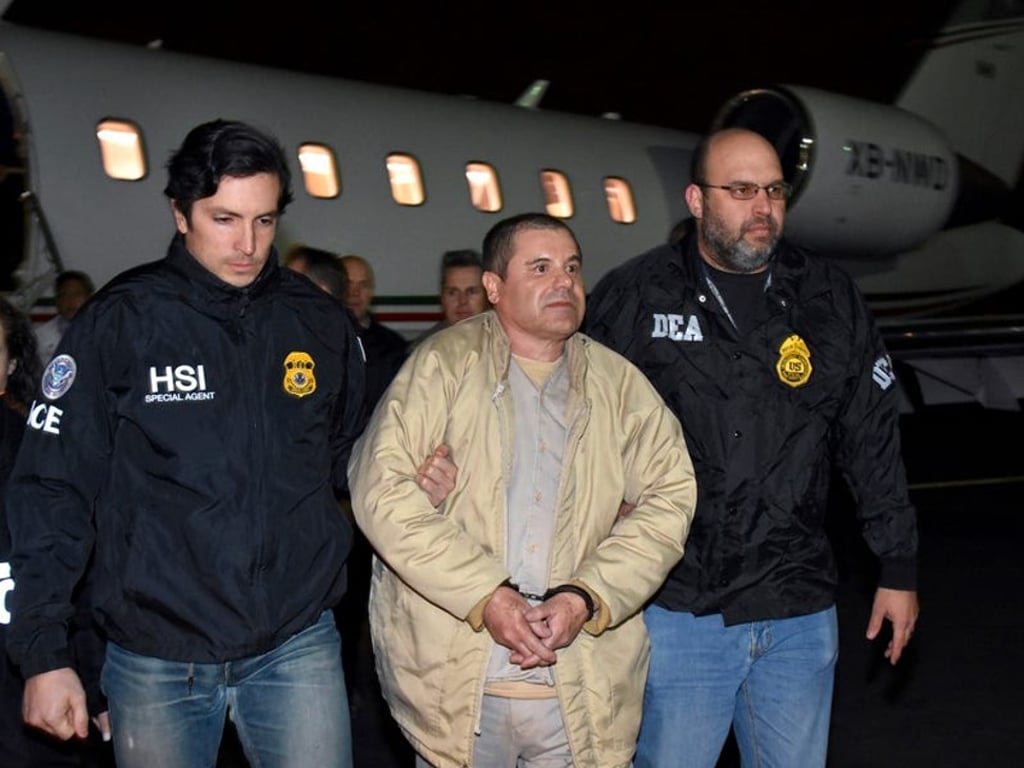 Mexican drug lord Joaquín ‘El Chapo’ Guzmán’s is escorted from a plane after his extradition to the United States in 2017. Photo: AP