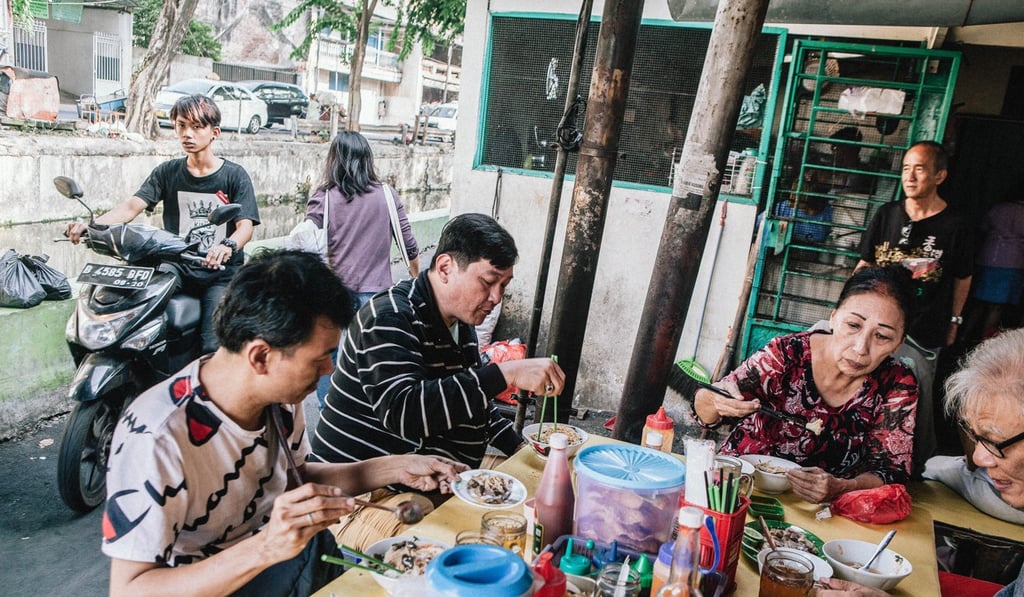 Diners at Bakmi Ahong, where noodles topped with steamed chicken is a popular breakfast dish. Photo: Agoes Rudianto