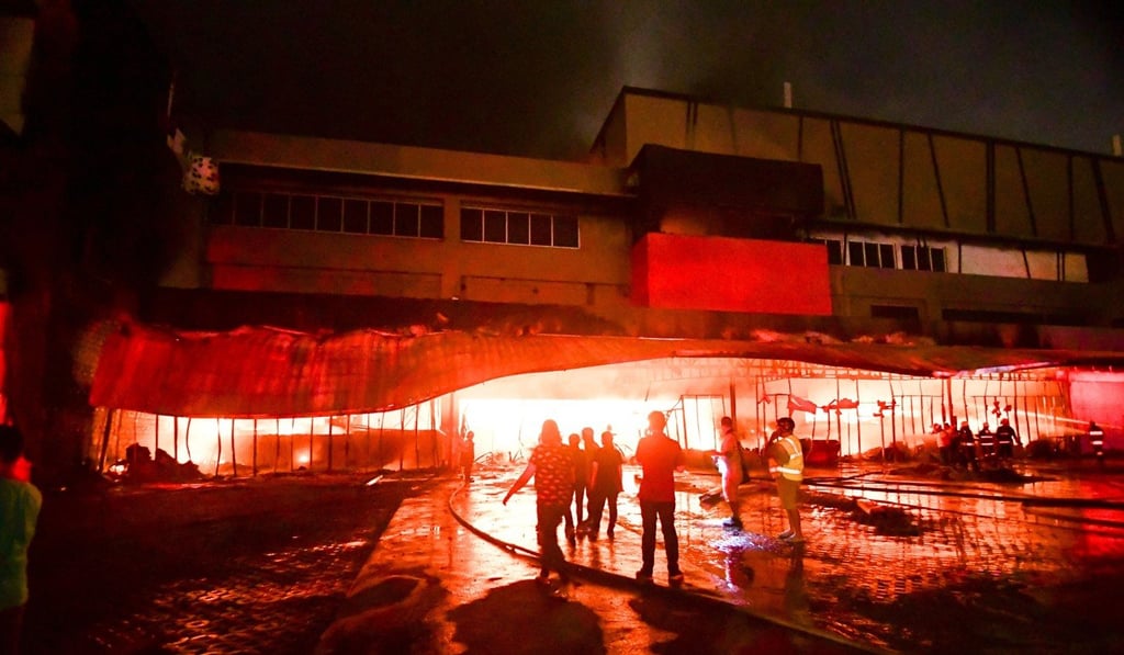 Firefighters try to put out a fire inside a mall in General Santos City. Photo: AFP