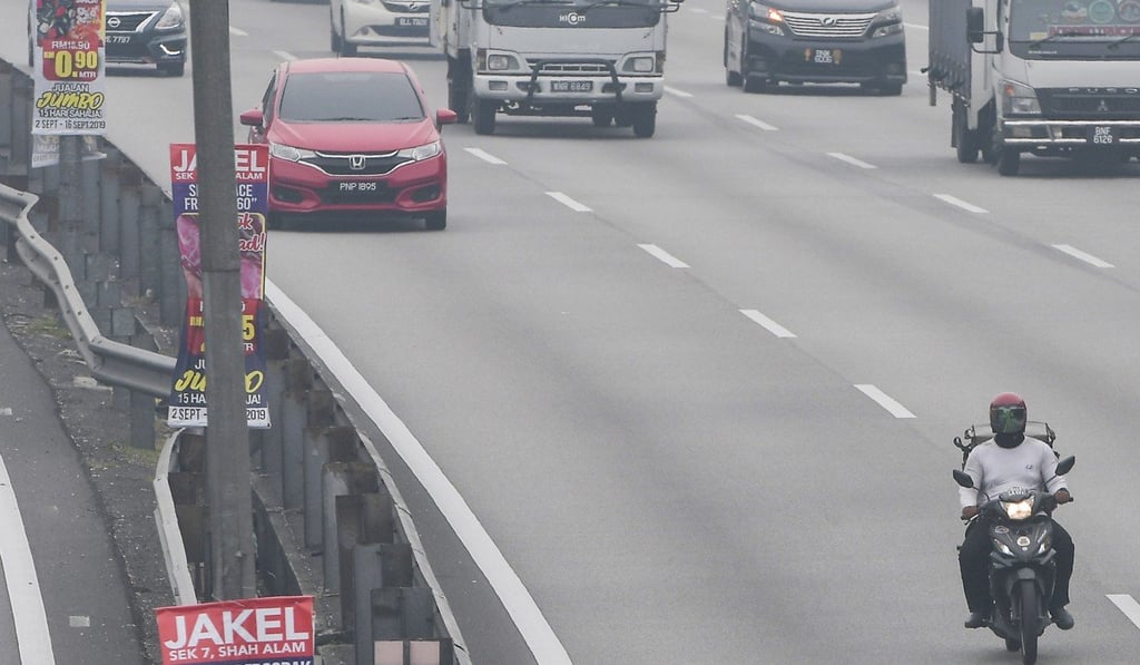 A courier rides his motorcycle on a busy road in Kuala Lumpur. Malaysia has some of the deadliest roads in Asia. A courier rides his motorcycle on a busy road in Kuala Lumpur. Malaysia has some of the deadliest roads in Asia.