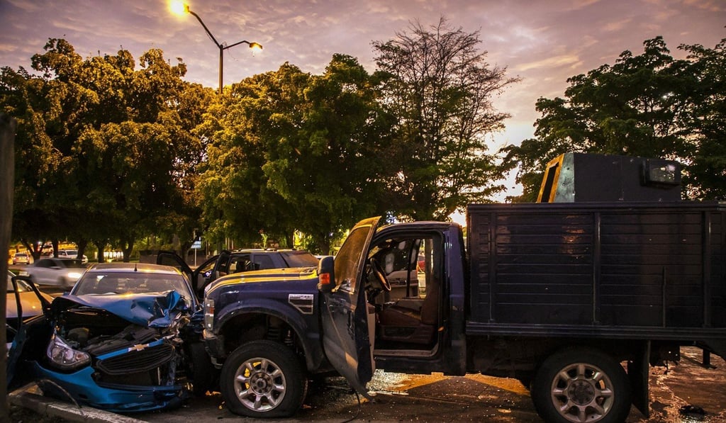 Bullet-ridden and crashed vehicles in a street of Culiacan. Photo: AFP