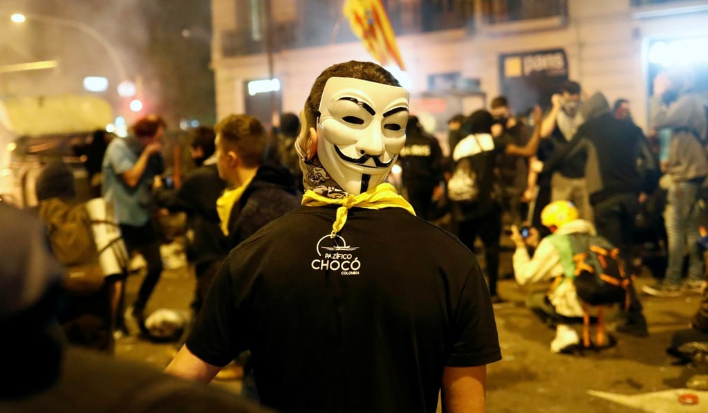 A demonstrator wears a Guy Fawkes mask during Catalonia's general strike in Barcelona on Friday. Photo: Reuters A demonstrator wears a Guy Fawkes mask during Catalonia's general strike in Barcelona on Friday. Photo: Reuters