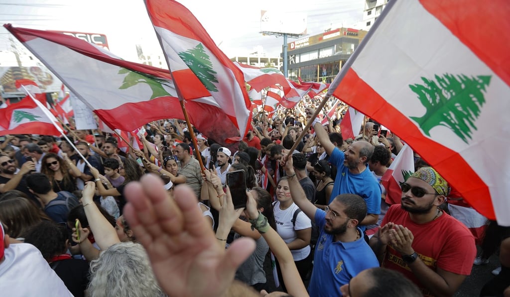 Lebanese demonstrators chant slogans and wave national flags in Beirut. Photo: AFP Lebanese demonstrators chant slogans and wave national flags in Beirut. Photo: AFP