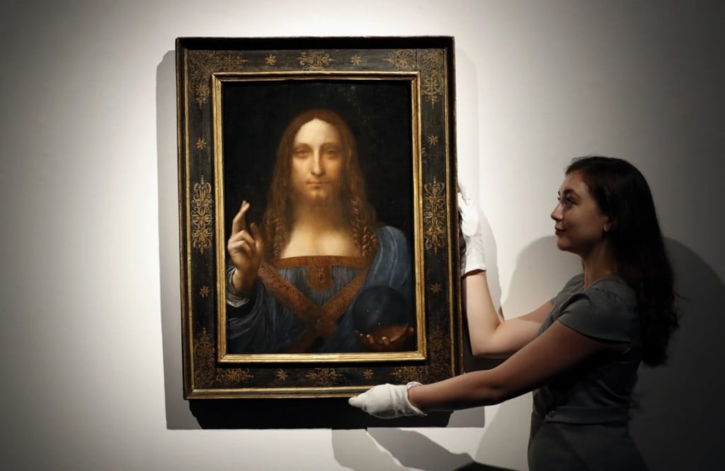 A Christie’s employee with Da Vinci’s Salvator Mundi on display in an auction room in London in 2017. Photo: AP