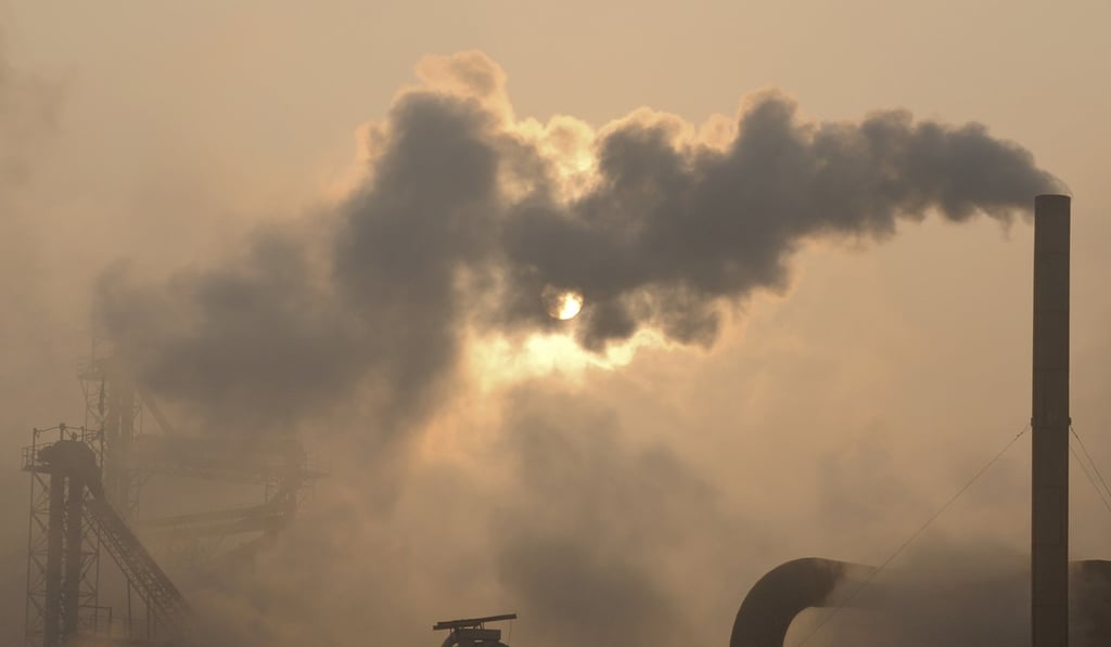 Smoke is emitted from chimneys of a cement plant in Binzhou city, in eastern China's Shandong province. Photo: AP