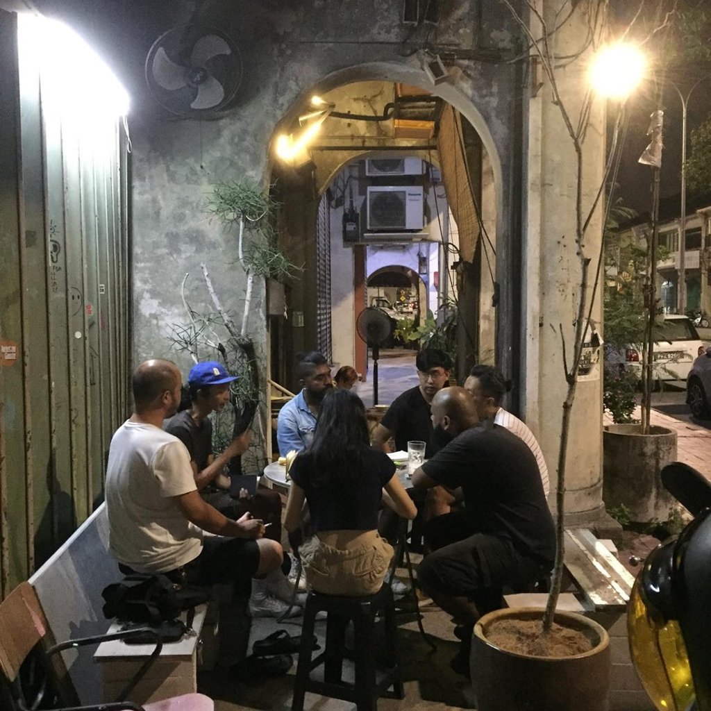 People whiling the night away at Narrow Marrow cafe in George Town. Photo: Facebook/Narrow Marrow