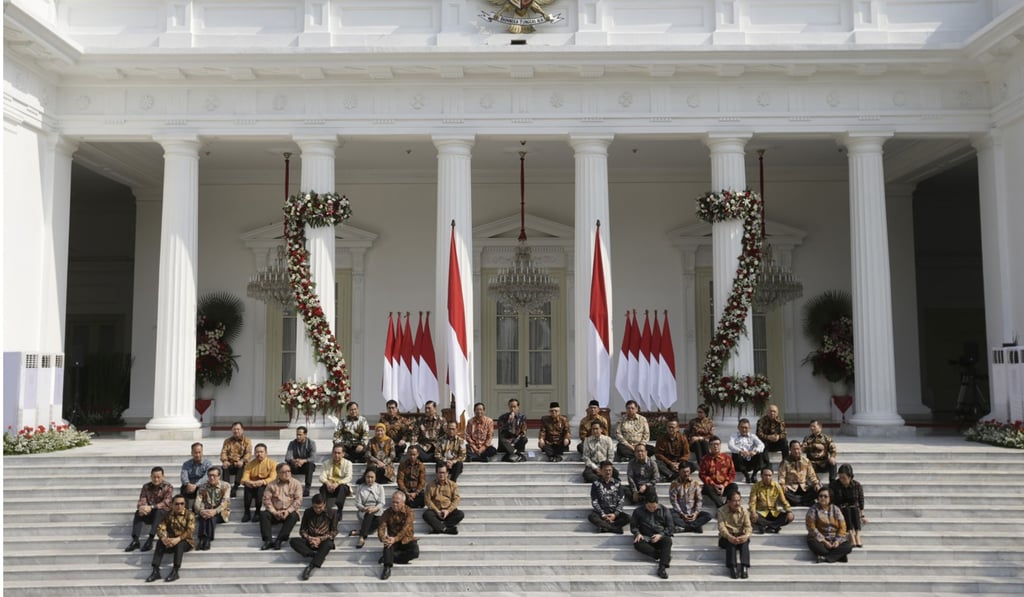 Cabinet ministers perch on the steps of the Merdeka Palace on Wednesday. Photo: AP Cabinet ministers perch on the steps of the Merdeka Palace on Wednesday. Photo: AP