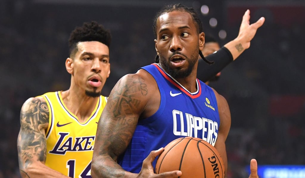 Kawhi Leonard, of the LA Clippers, spins for a shot in front of the Lakers’ Danny Green during their NBA game on Tuesday night. Photo: AFP