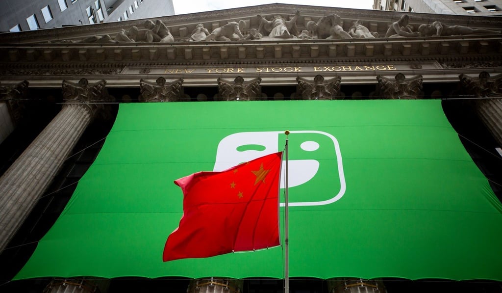 A Chinese flag flies in front of Laix signage during the company's initial public offering outside the New York Stock Exchange on Sept. 27, 2018. Photo: Bloomberg