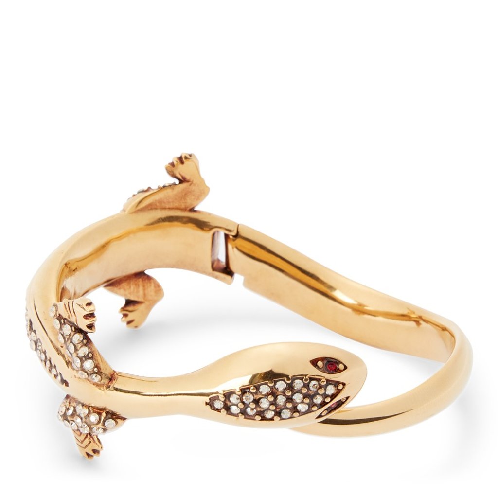 Cuff bracelet with the brand’s gecko emblem.