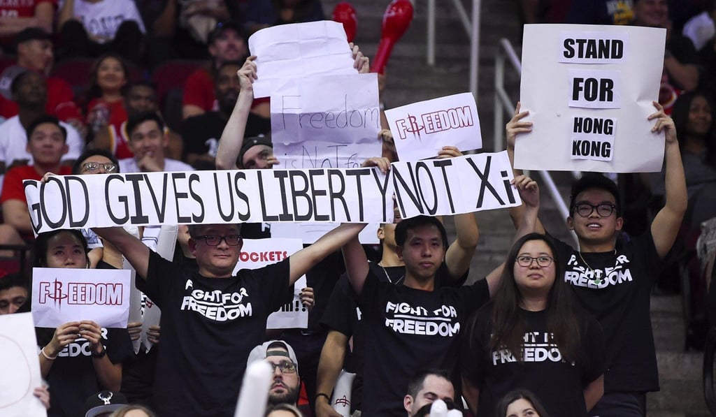 Fans in Houston, Texas, hold signs about the pro-democracy movement in Hong Kong during an NBA game between the host Rockets and the Milwaukee Bucks on Thursday. Photo: AP
