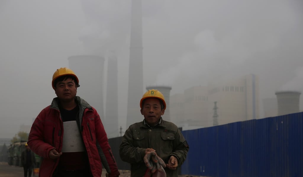 Workers walk near a power plant during a polluted day in Beijing in December 2018. One goal of the Ubiquitous Power Internet of Things project is to draw on multiple sources of renewable clean energy for power. Photo: EPA-EFE