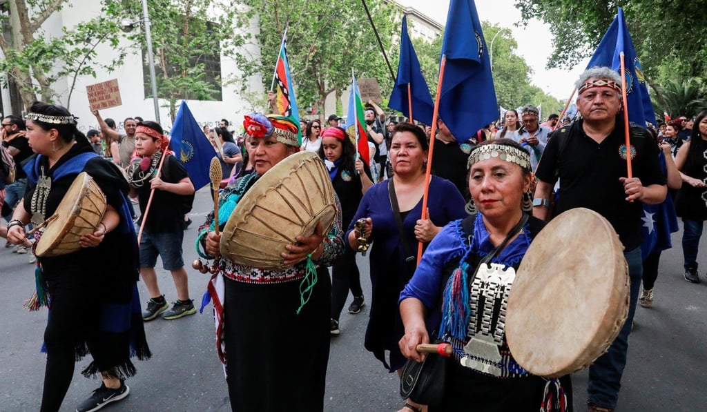 Protesters bang drums during an anti-government march in Santiago. Photo: Reuters