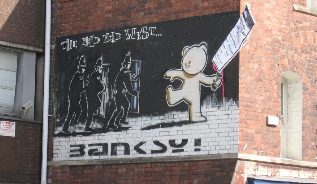 Banksy mural The Mild, Mild West, with added poster. Photo: Wikipedia Banksy mural The Mild, Mild West, with added poster. Photo: Wikipedia