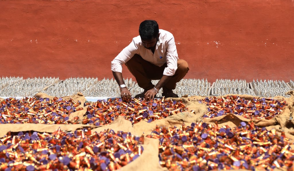 A worker lays firecrackers in an outdoor yard at a manufacturing unit involved in the production of firecrackers ahead of the Hindu festival of Diwali, in Sivakasi. Photo: AFP
