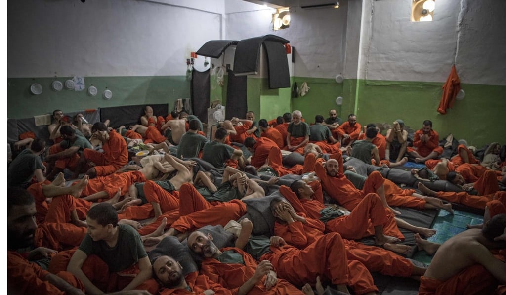 Men, suspected of being affiliated with Isis, pack a cell. Photo: AFP Men, suspected of being affiliated with Isis, pack a cell. Photo: AFP