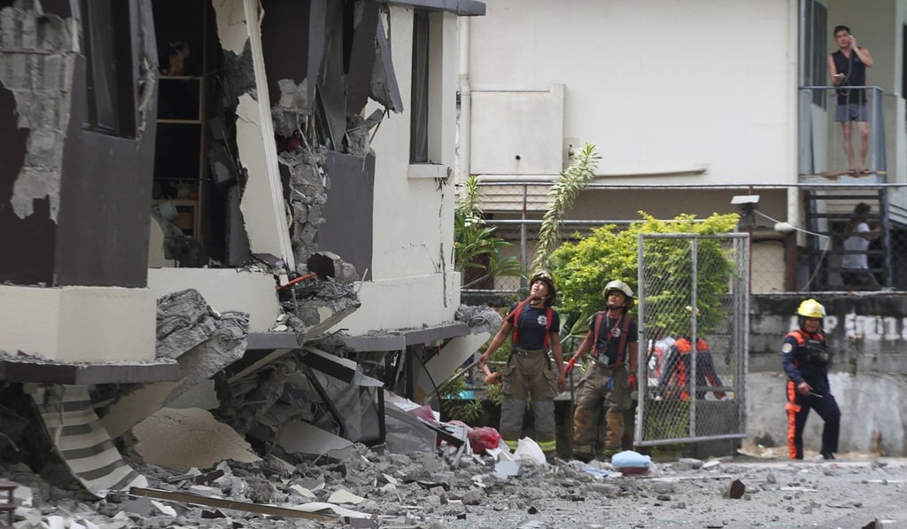 Rescuers look at a damaged condominium building in Davao City after the latest earthquake hit the region. Photo: AFP Rescuers look at a damaged condominium building in Davao City after the latest earthquake hit the region. Photo: AFP