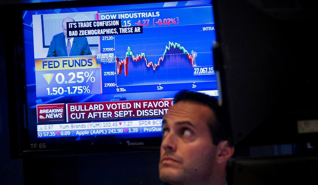 A screen displays the US Federal Reserve interest rate announcement as traders work on the floor of the New York Stock Exchange on Wednesday. Photo: Reuters