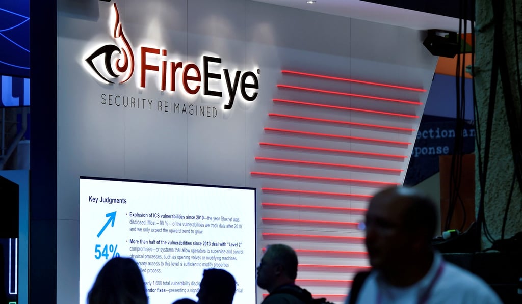 Attendees walk by the FireEye booth during the Black Hat cybersecurity conference in Las Vegas in August 2016. Photo: Reuters