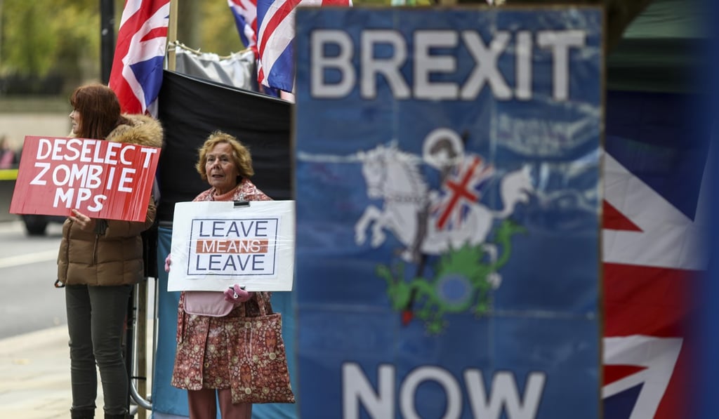 Pro-Brexit demonstrators hold placards near the Houses of Parliament in London on Monday. Photo: Bloomberg