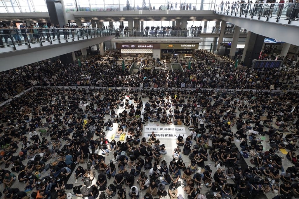 Black-clad laying siege to the Hong Kong airport’s departure hall on August 12, 2019. Photo: AP