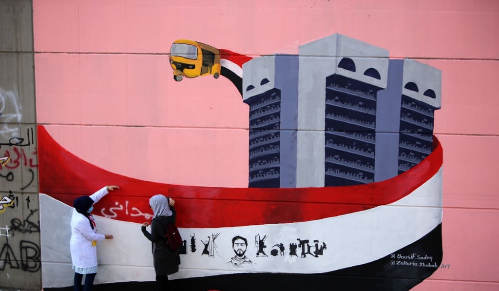 A mural in Tahrir Square shows a tuk-tuk and the once-empty building that protesters have now occupied. Photo: AFP A mural in Tahrir Square shows a tuk-tuk and the once-empty building that protesters have now occupied. Photo: AFP