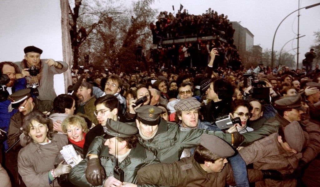 On November 12, 1989 East and West German Police try to contain the crowd of East Berliners flowing through the recent opening made in the Berlin Wall at Potsdamer Square. File photo: AFP On November 12, 1989 East and West German Police try to contain the crowd of East Berliners flowing through the recent opening made in the Berlin Wall at Potsdamer Square. File photo: AFP