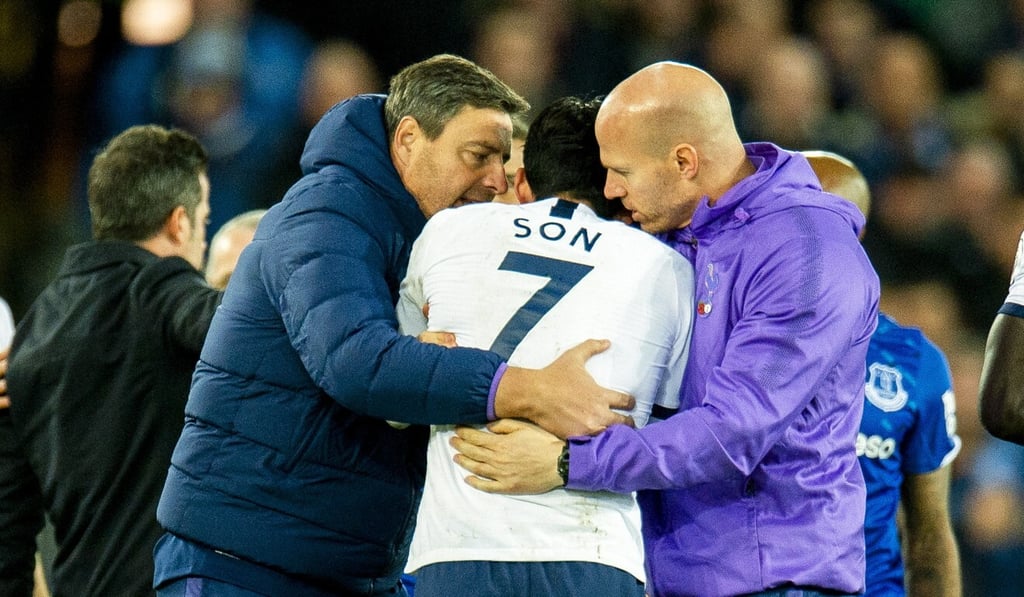 Tottenham Hotspur's Son Heung-min is consoled by staff. Photo: EPA