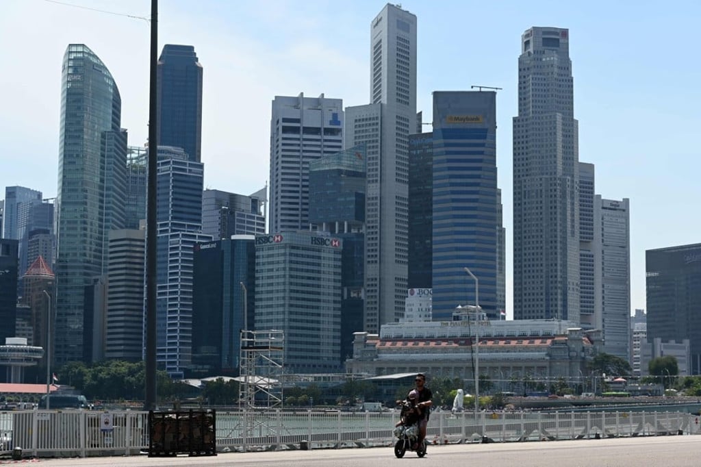 A couple ride on an e-scooter along Marina Bay in Singapore. Photo: AFP