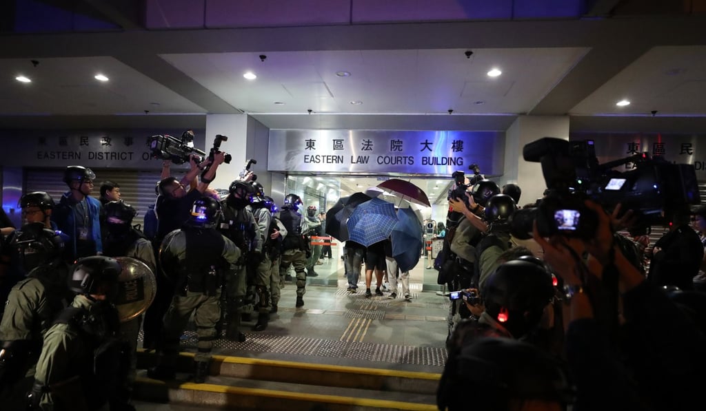 Anti-riot police on Monday enter Eastern Court in Sai Wan Ho, to “rearrest” several defendants who were released over a clerical miscue. Photo: Sam Tsang