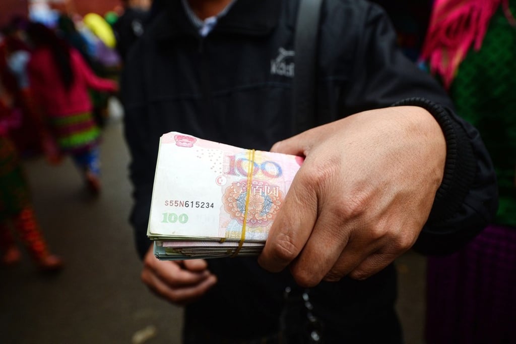 The yuan jumped by 0.59 per cent to 6.9890 on Tuesday, breaking a key resistance level of 7.00 to the dollar. Photo: AFP