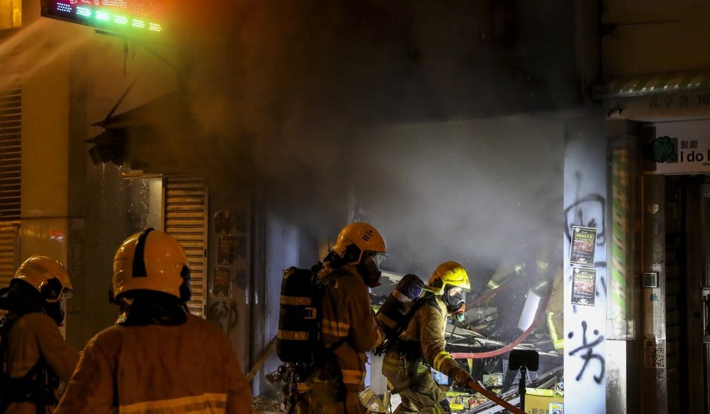 Firefighters put out a fire set by anti-government protesters in Mong Kok. Photo: K.Y. Cheng Firefighters put out a fire set by anti-government protesters in Mong Kok. Photo: K.Y. Cheng