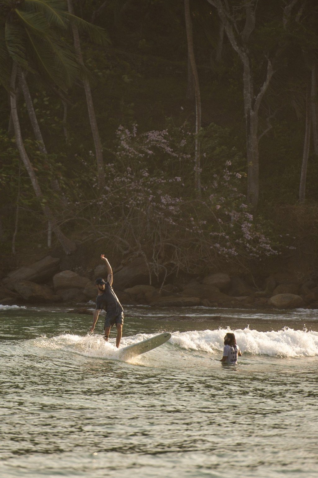 The gentle waves in Hiriketiya bay are ideal for longboard surfers. Photo: David Burden