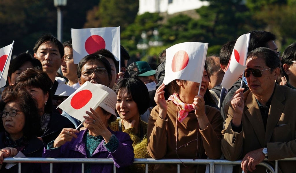 Japanese well-wishers hold Japanese national flags. Photo: AP