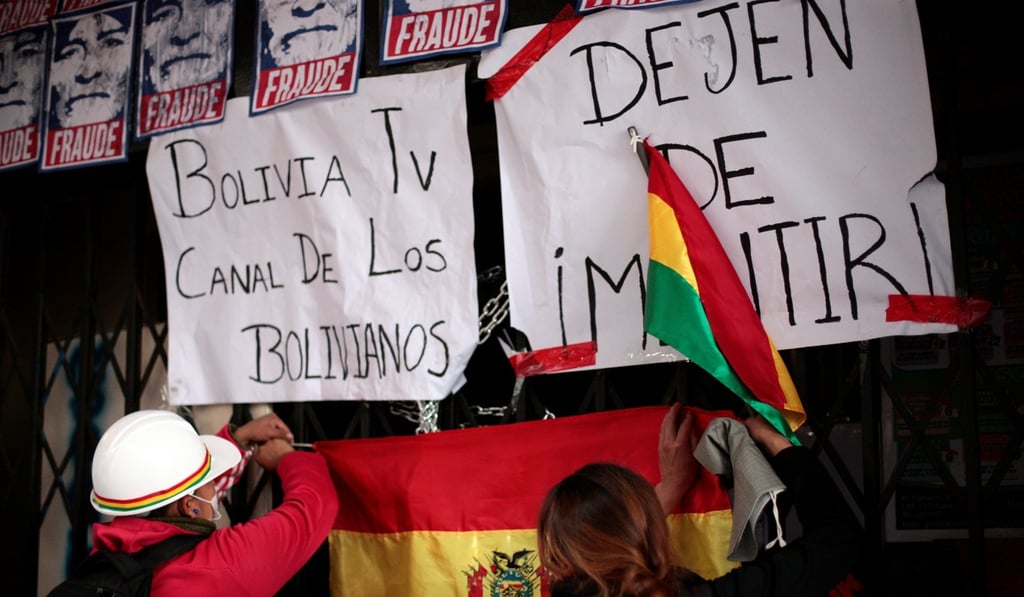 Demonstrators are seen plastering the facilities of the state-run Bolivia TV and Radio Patria Nueva with posters. Photo: Reuters